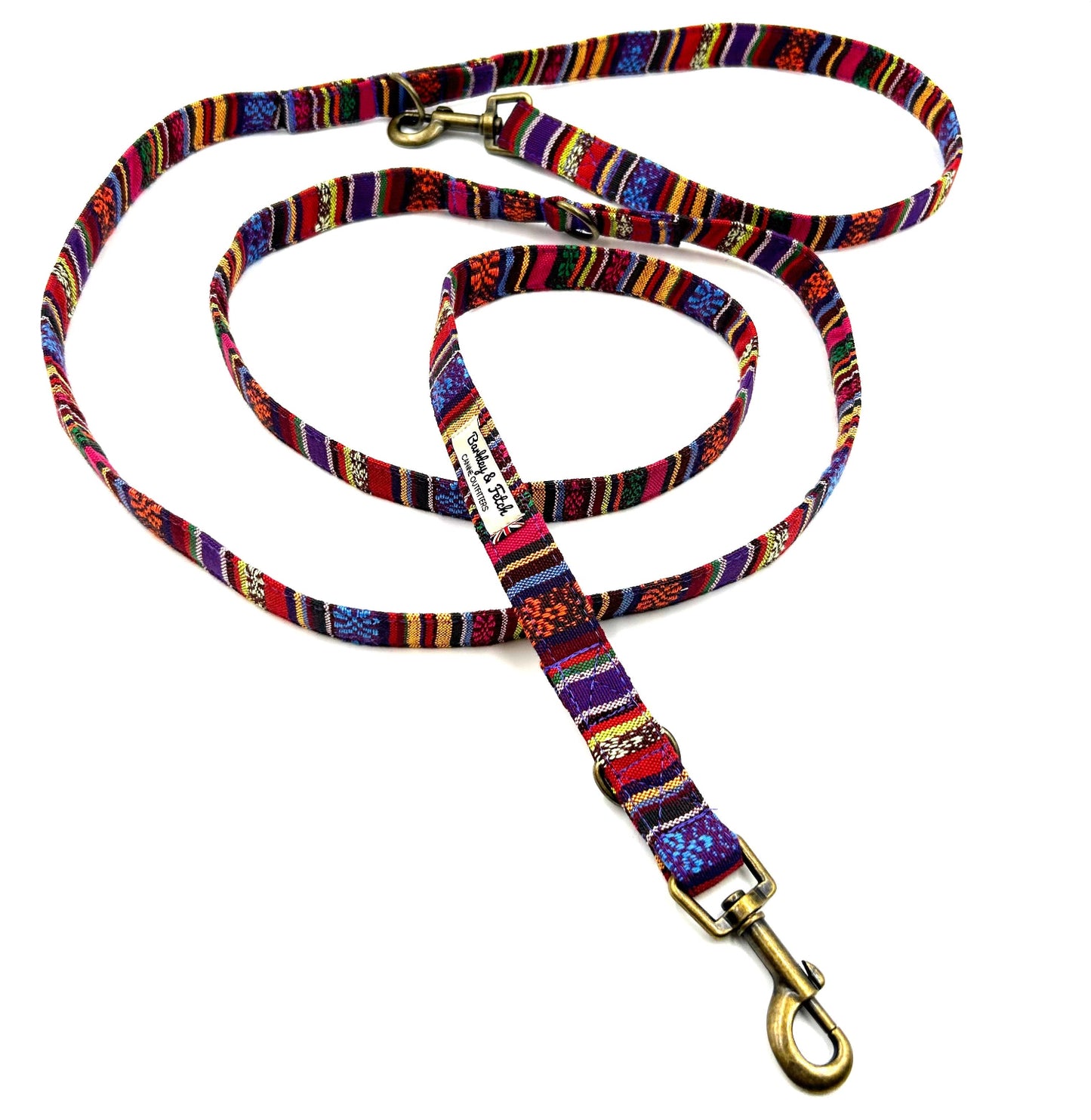 Colorful striped dog leash with gold clasp on a white background