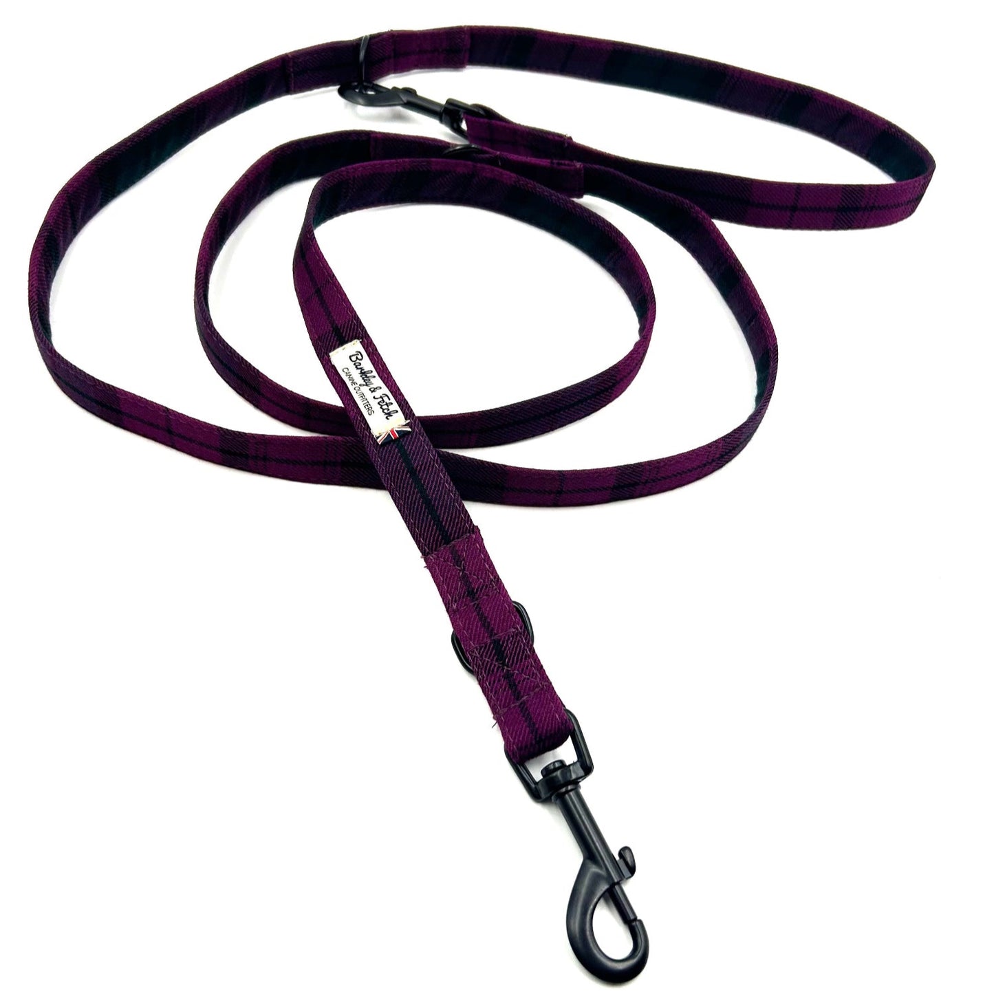 Purple dog leash with a metal clip on a white background