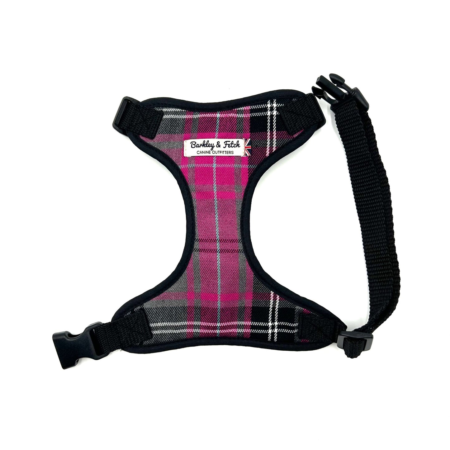 A pink and grey tartan dog harness with adjustable straps and a side release buckle.