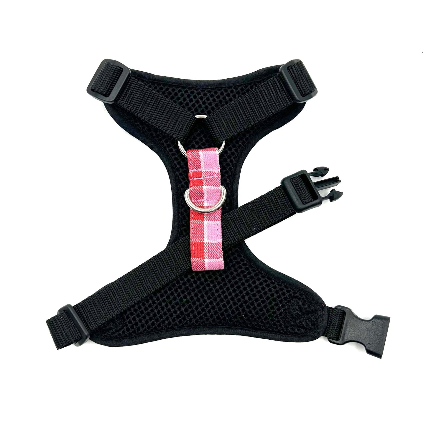 Black dog harness with a pink plaid bow on a white background