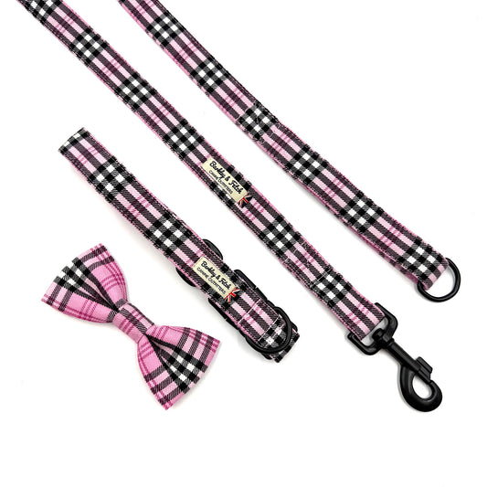 Pink and black checkered dog leash with bow tie on a white background