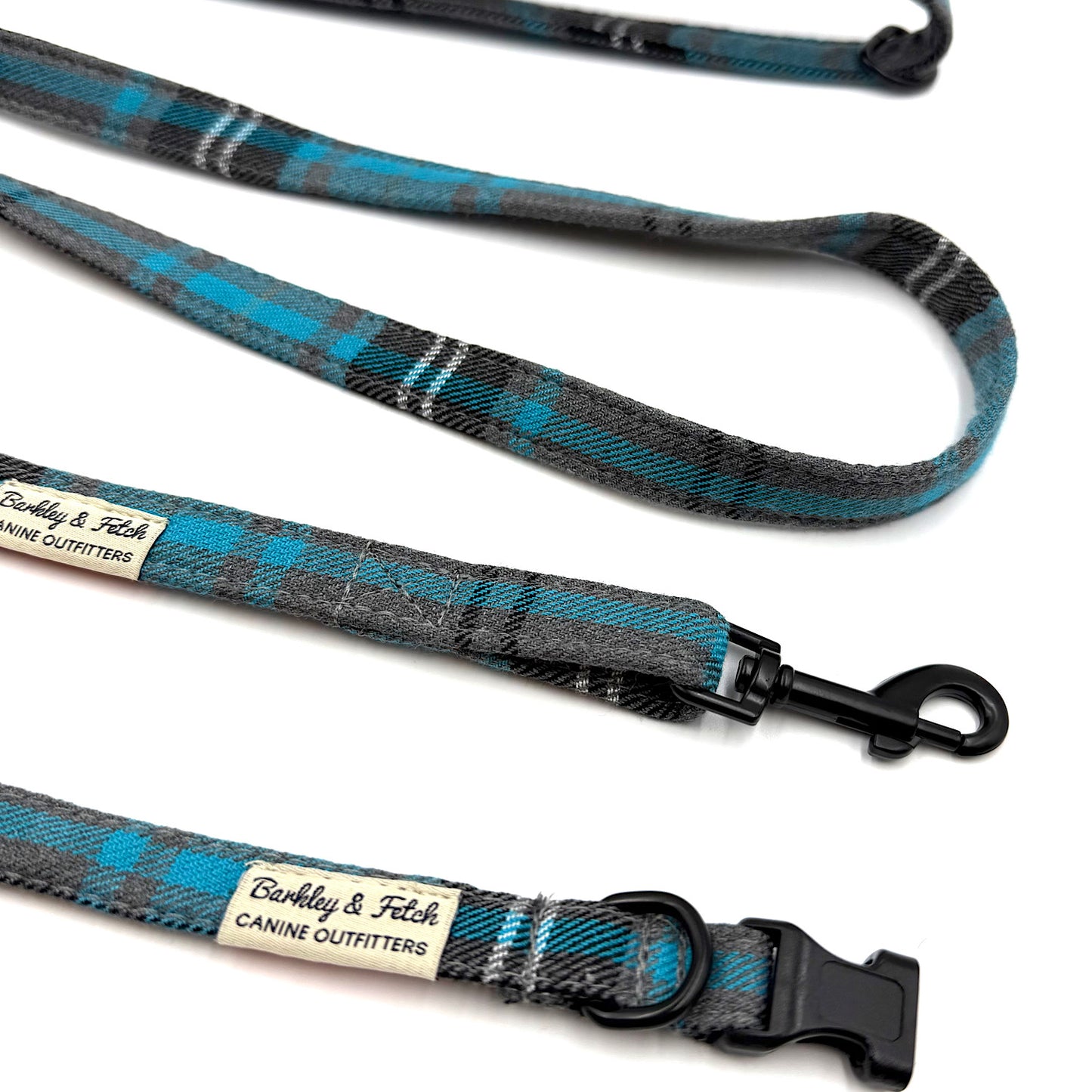 Blue and gray plaid dog leash with black hardware on a white background