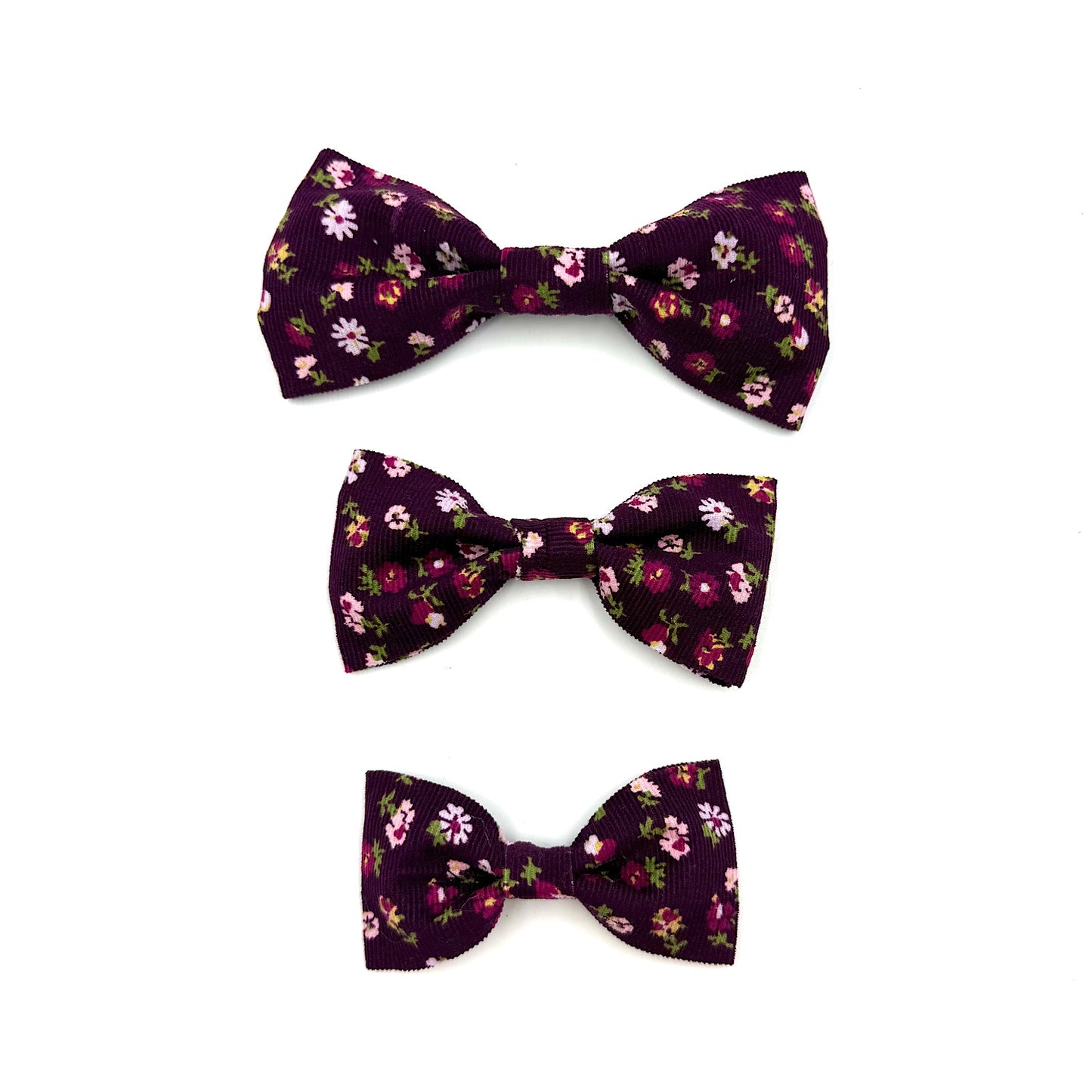 Three floral-patterned bow ties on a white background