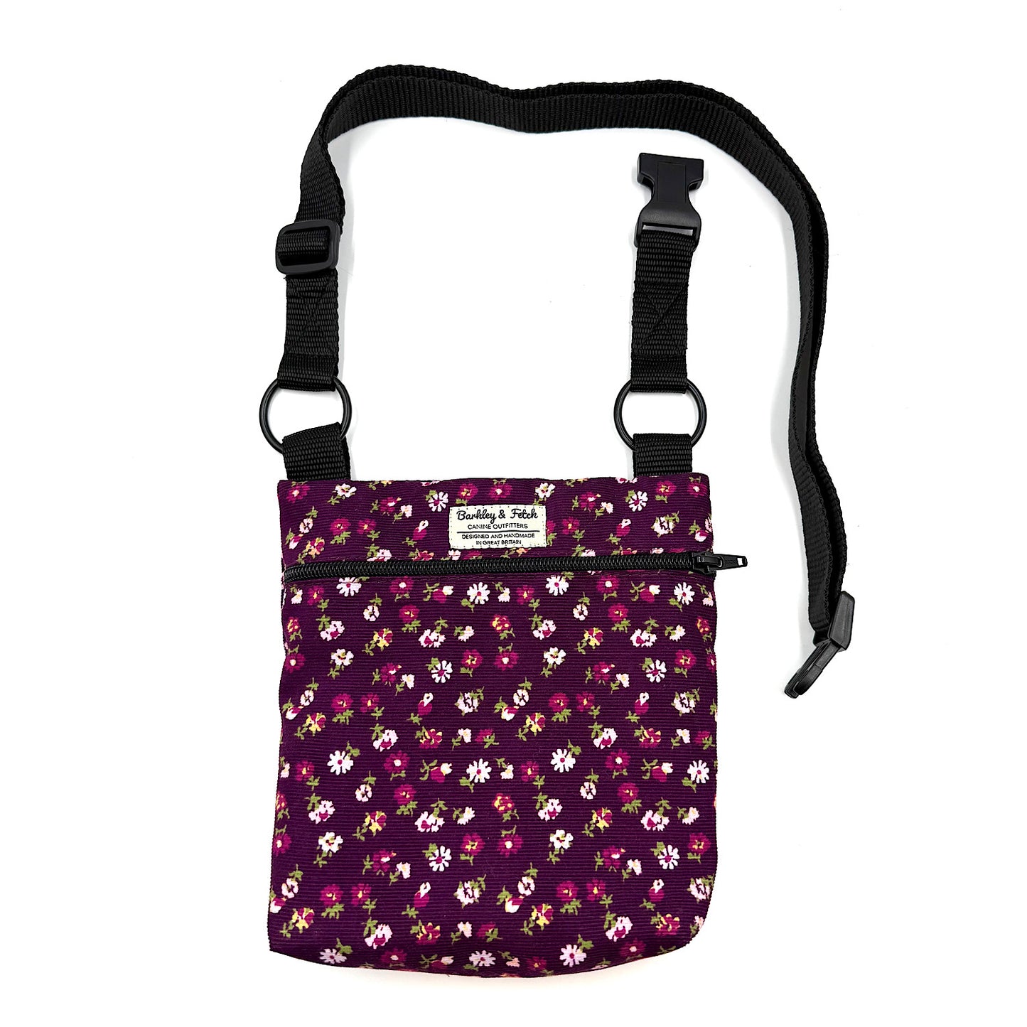 Floral-patterned pouch with a black strap on a white background