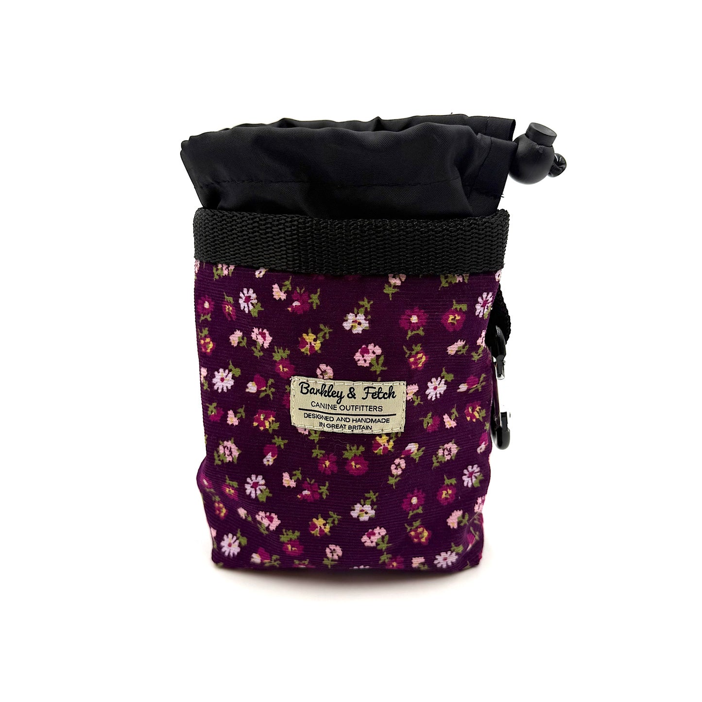 Floral-patterned treat bag with black top on a white background