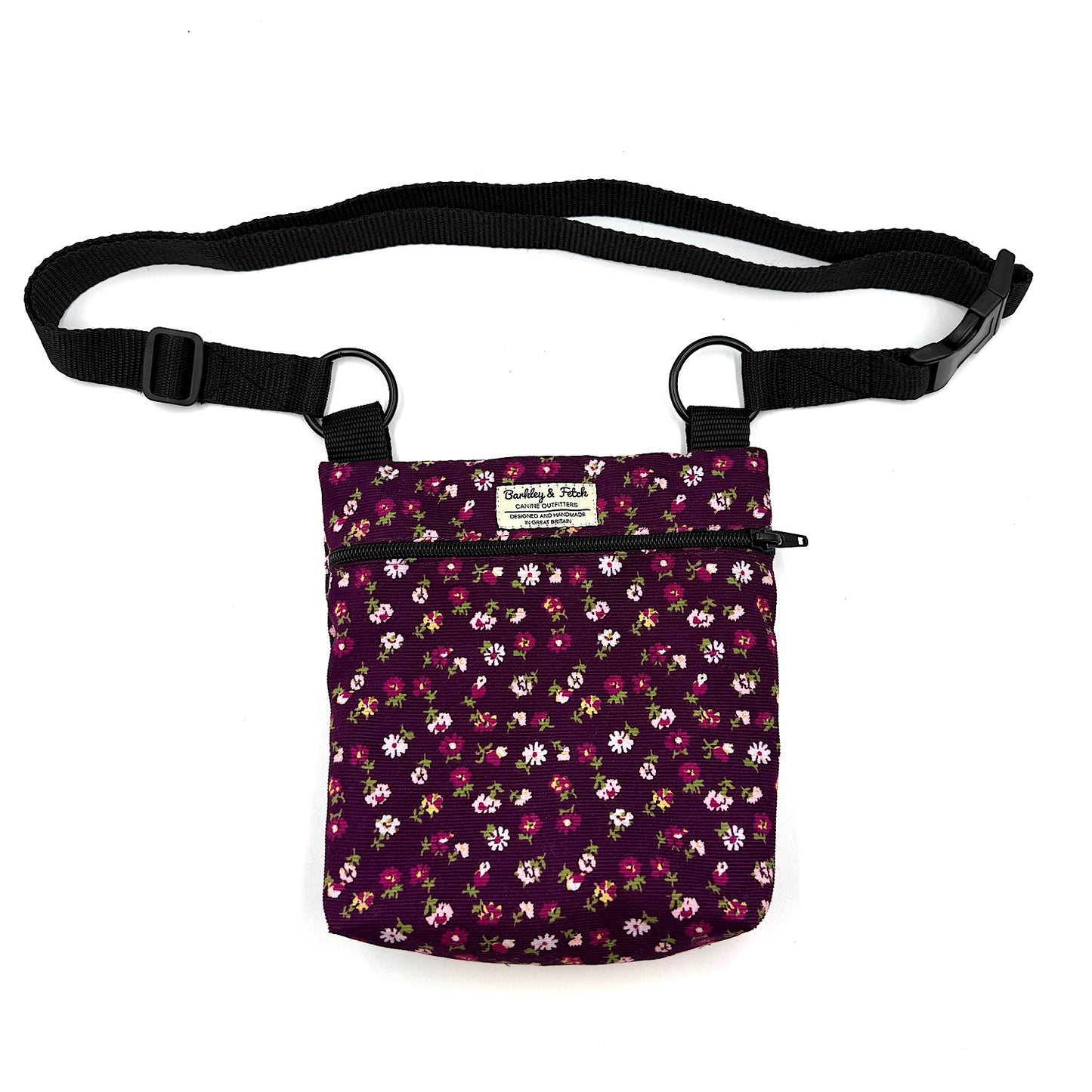 Floral-patterned pouch with a black strap on a white background