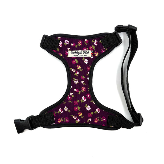 Floral-patterned dog harness with black straps on a white background