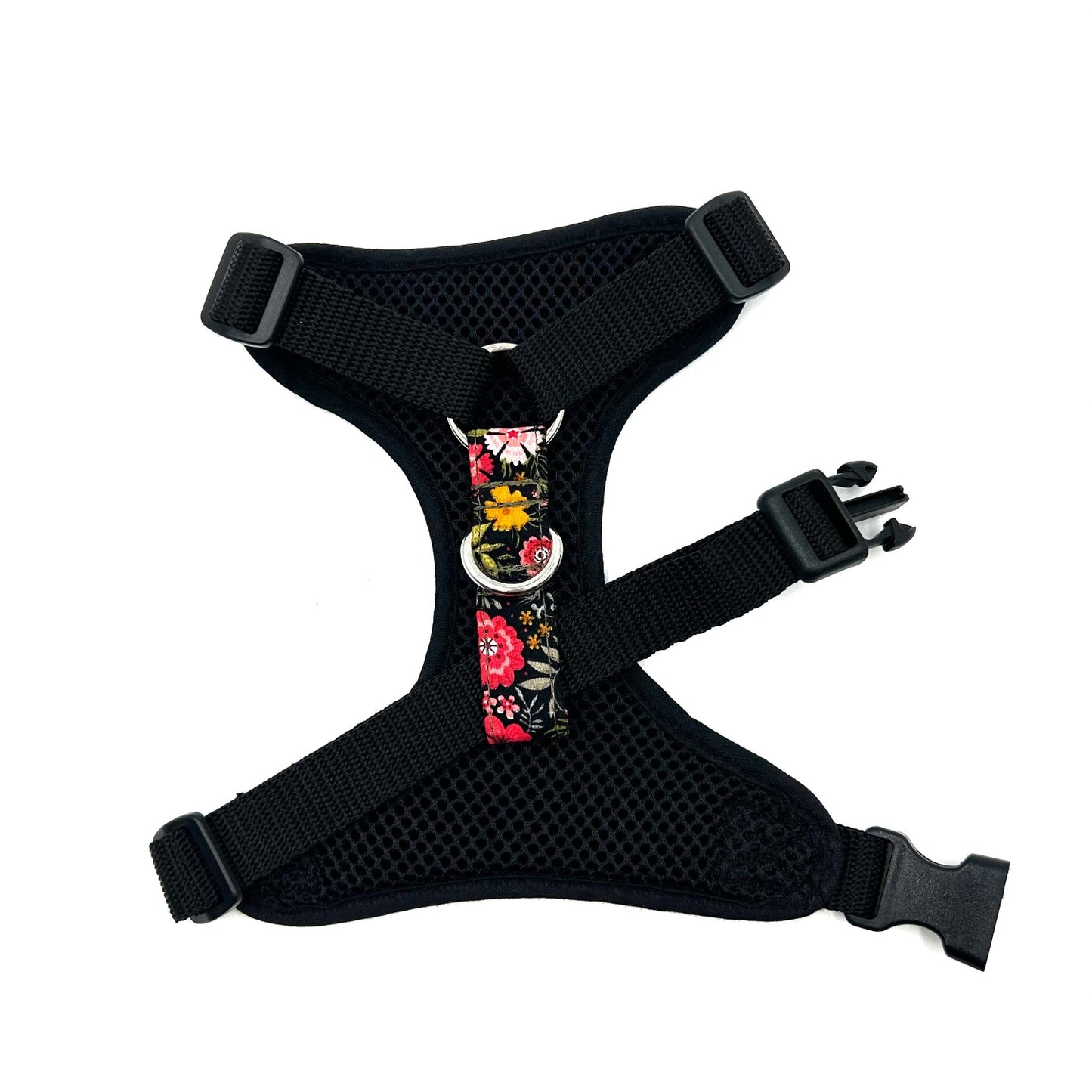 Black dog harness with floral design on a white background