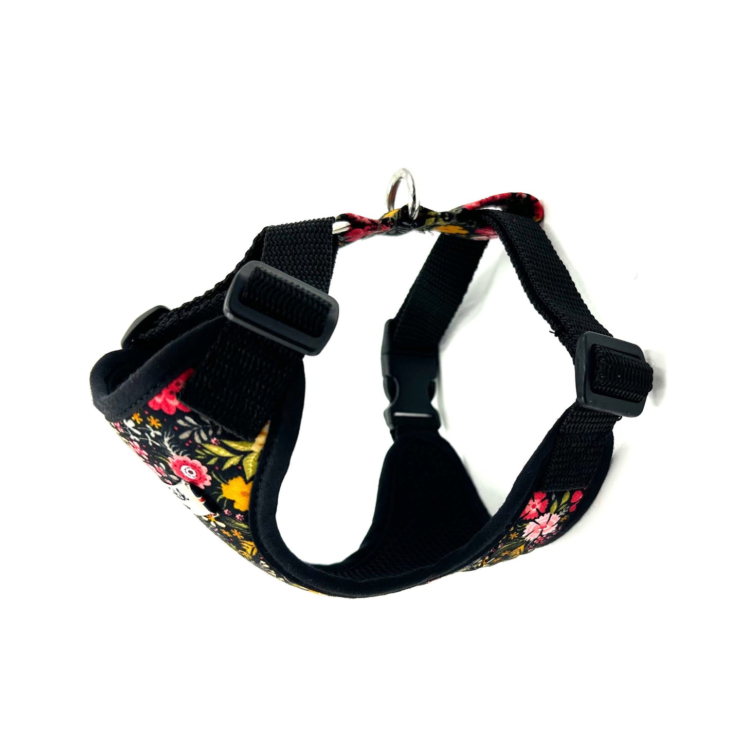 Black dog harness with floral pattern on a white background