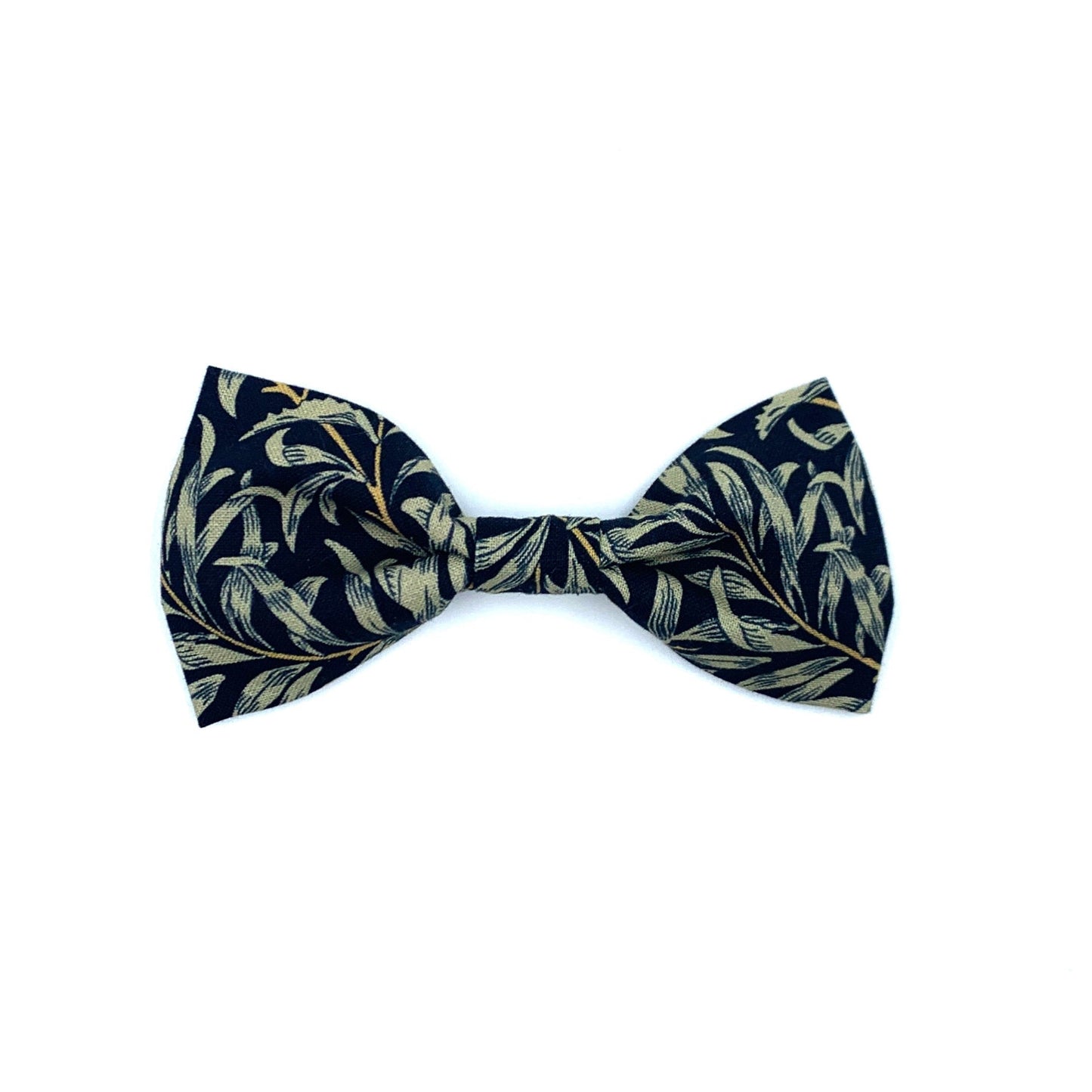 A dog bowtie with a black willow print, featuring a leaf pattern, on a navy background.