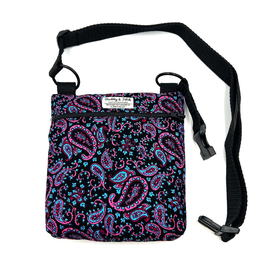 Small bag with pink and blue paisley pattern on a black strap against a white background. Handmade in the UK by Barkley and Fetch