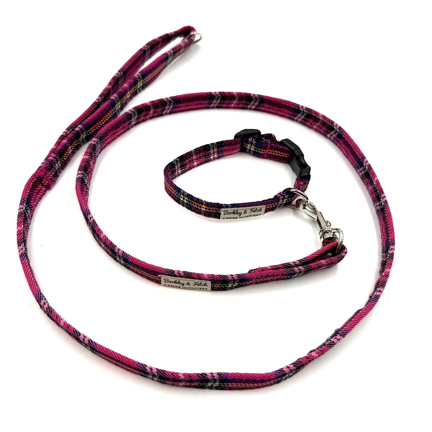 Dog leash and collar set with pink and black plaid pattern on a white background