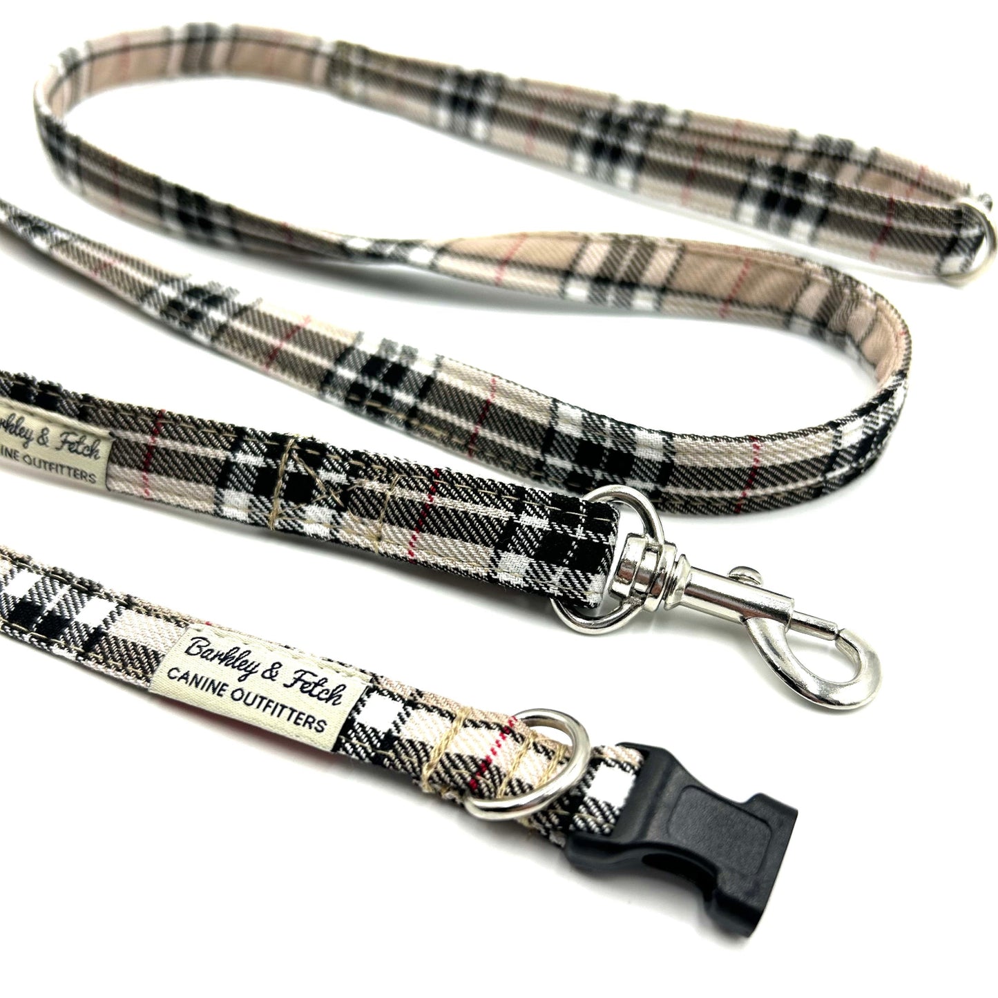 Plaid dog leash with metal clip and black clip on a white background