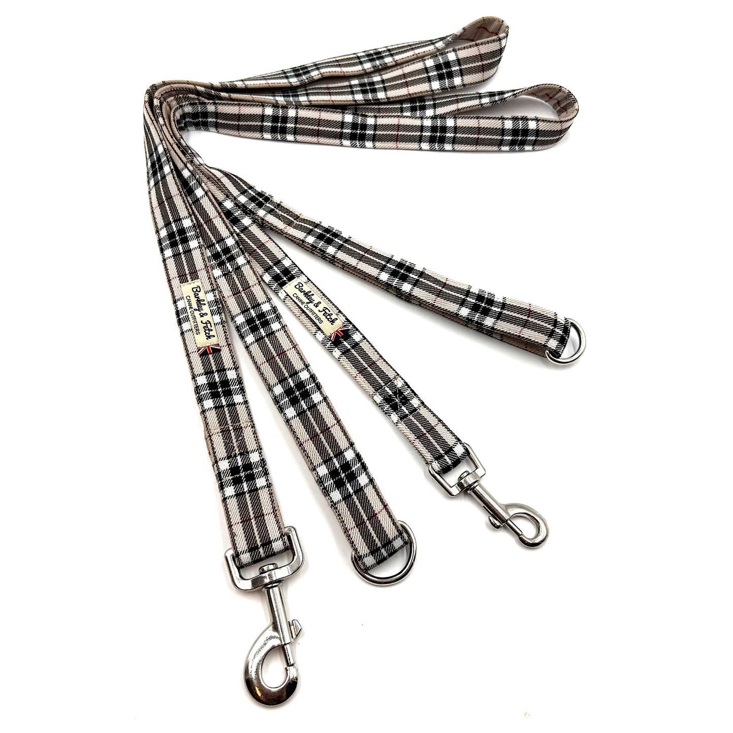 Plaid patterned dog leashes with metal clips on a white background