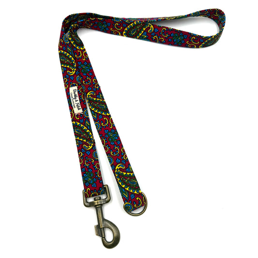 Colorful patterned dog leash with a metal clip on a white background