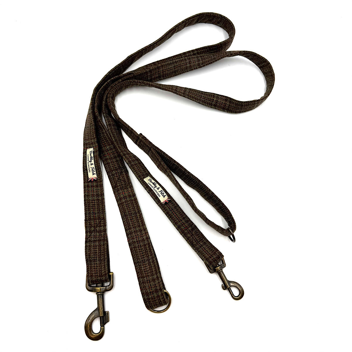 two brown and black plaid dog leads with antique bronze metal swivels, The leashes is laid out on a clean white background. Handmade in Great Britain by Barkley and Fetch.