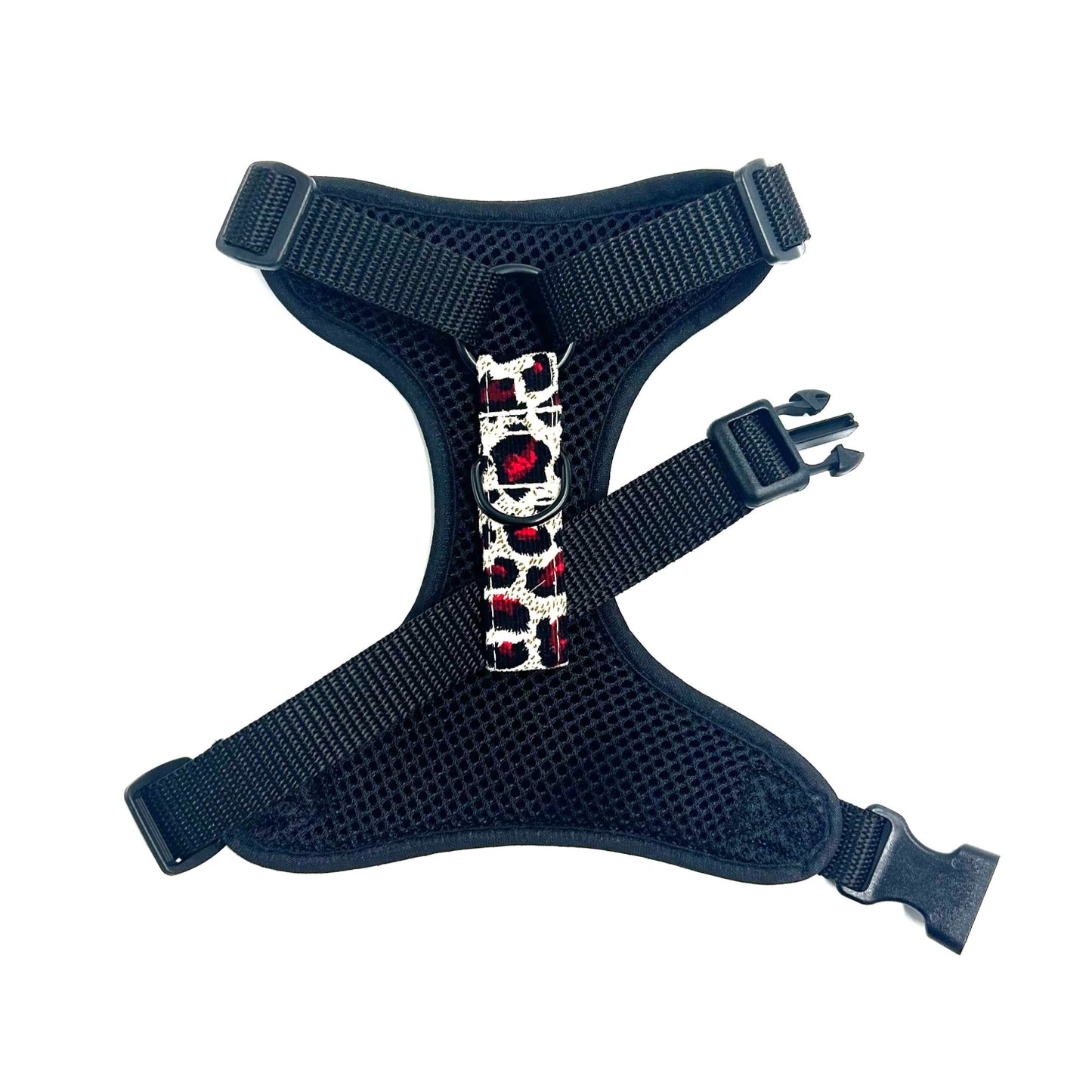 back of dog harness with a decorative red and white buckle on a white background