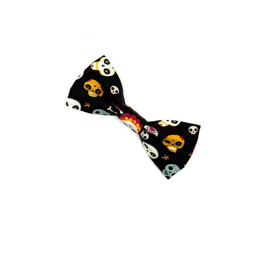 Black bow tie with colorful skull pattern on a white background