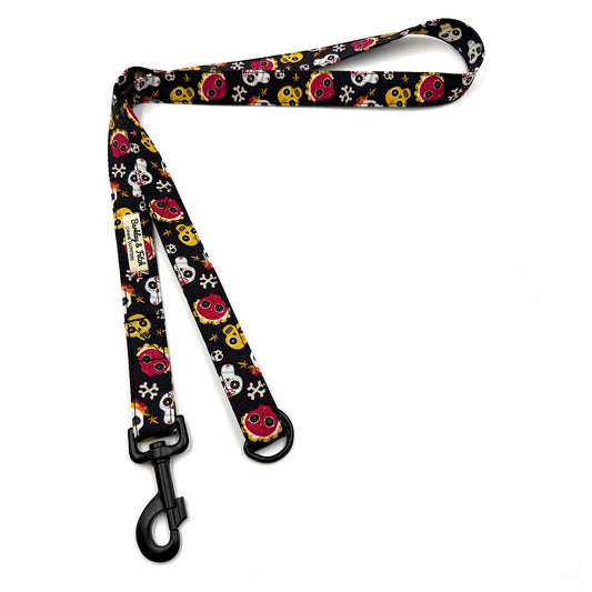 Dog leash with colorful skull pattern on a white background