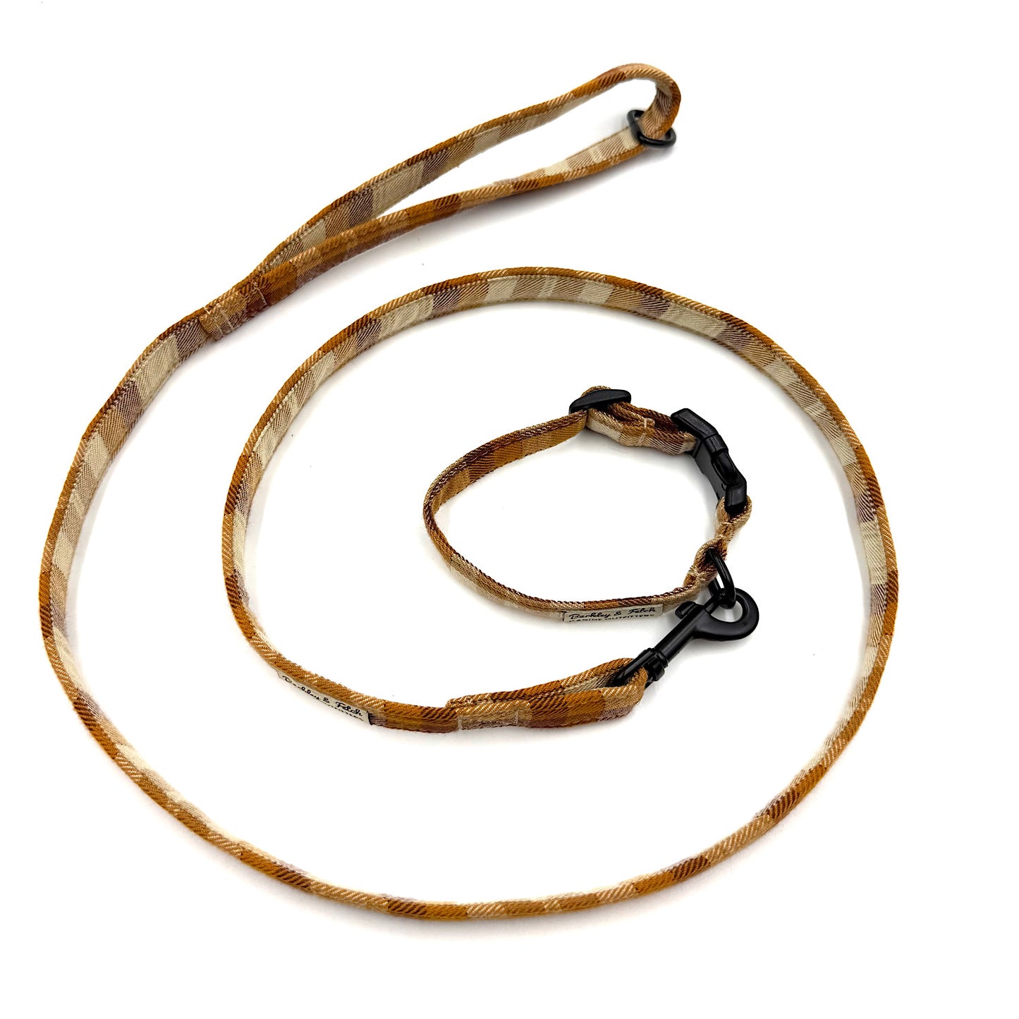 Brown dog leash with black clip on a white background