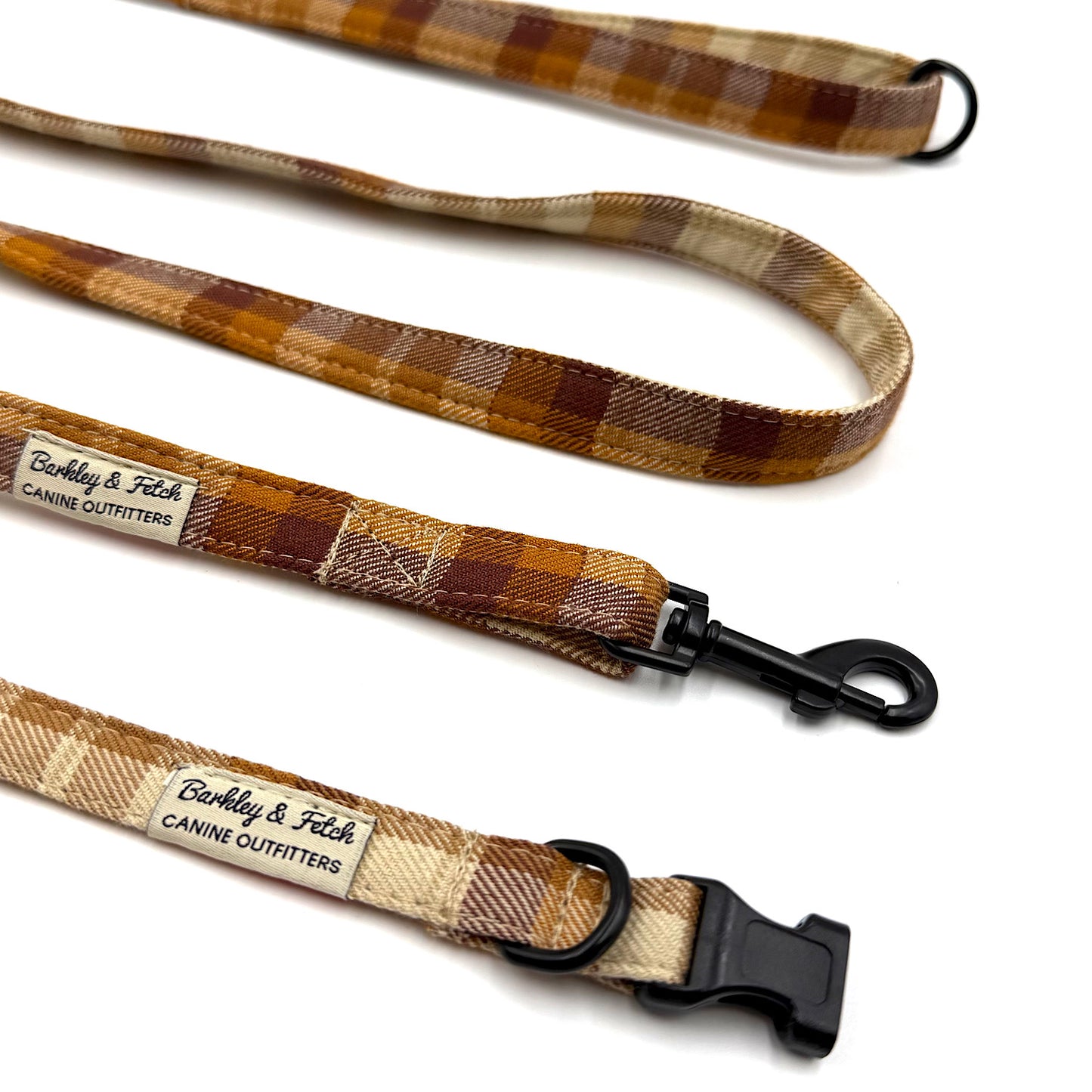 Plaid dog leash with black clip and visible brand label on a white background
