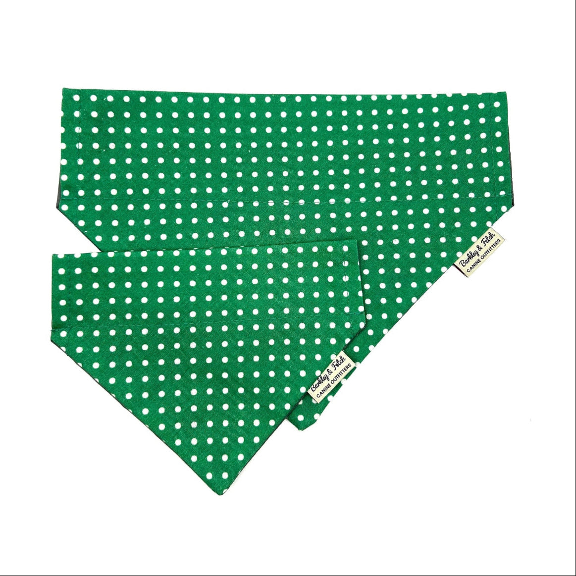 Green polka dot bandana with a brand tag on a white background handmade by barkley and fetch uk