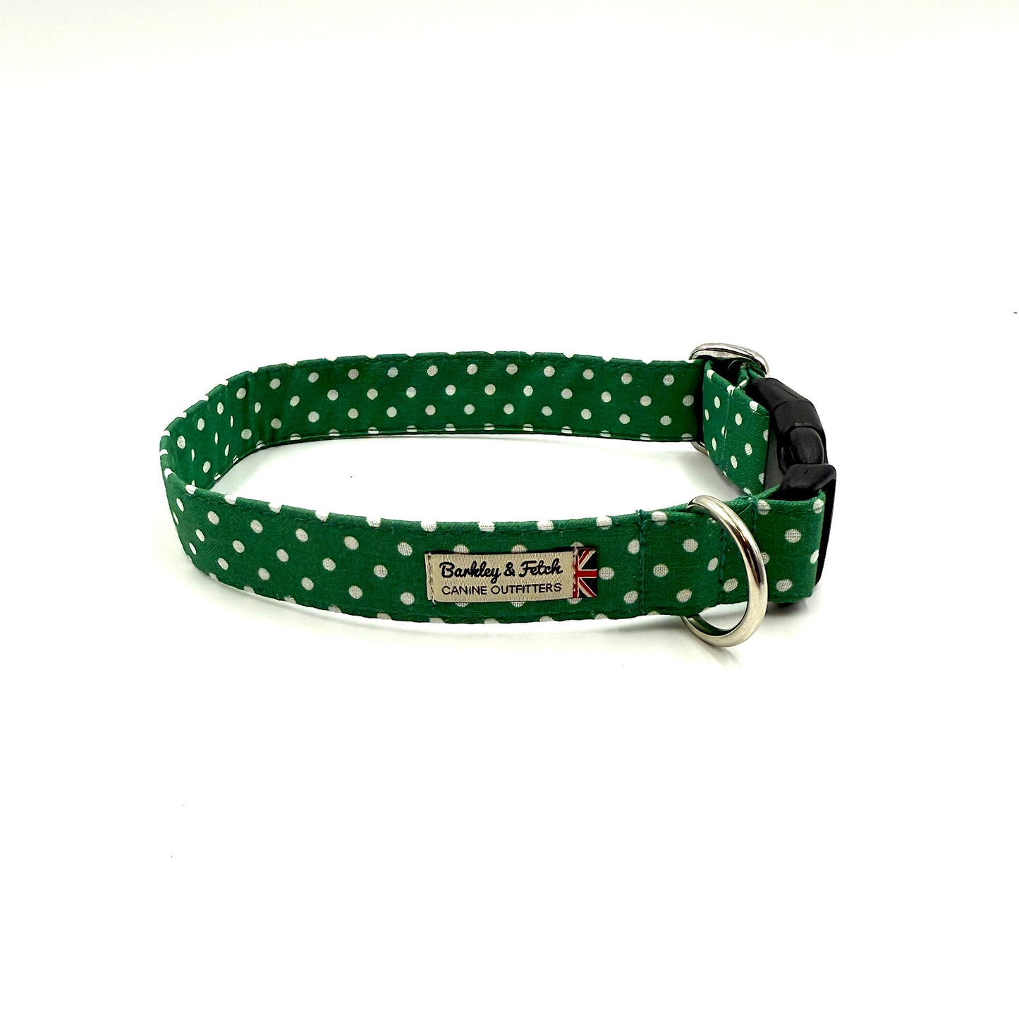 Green dog collar with white polka dots on a white background