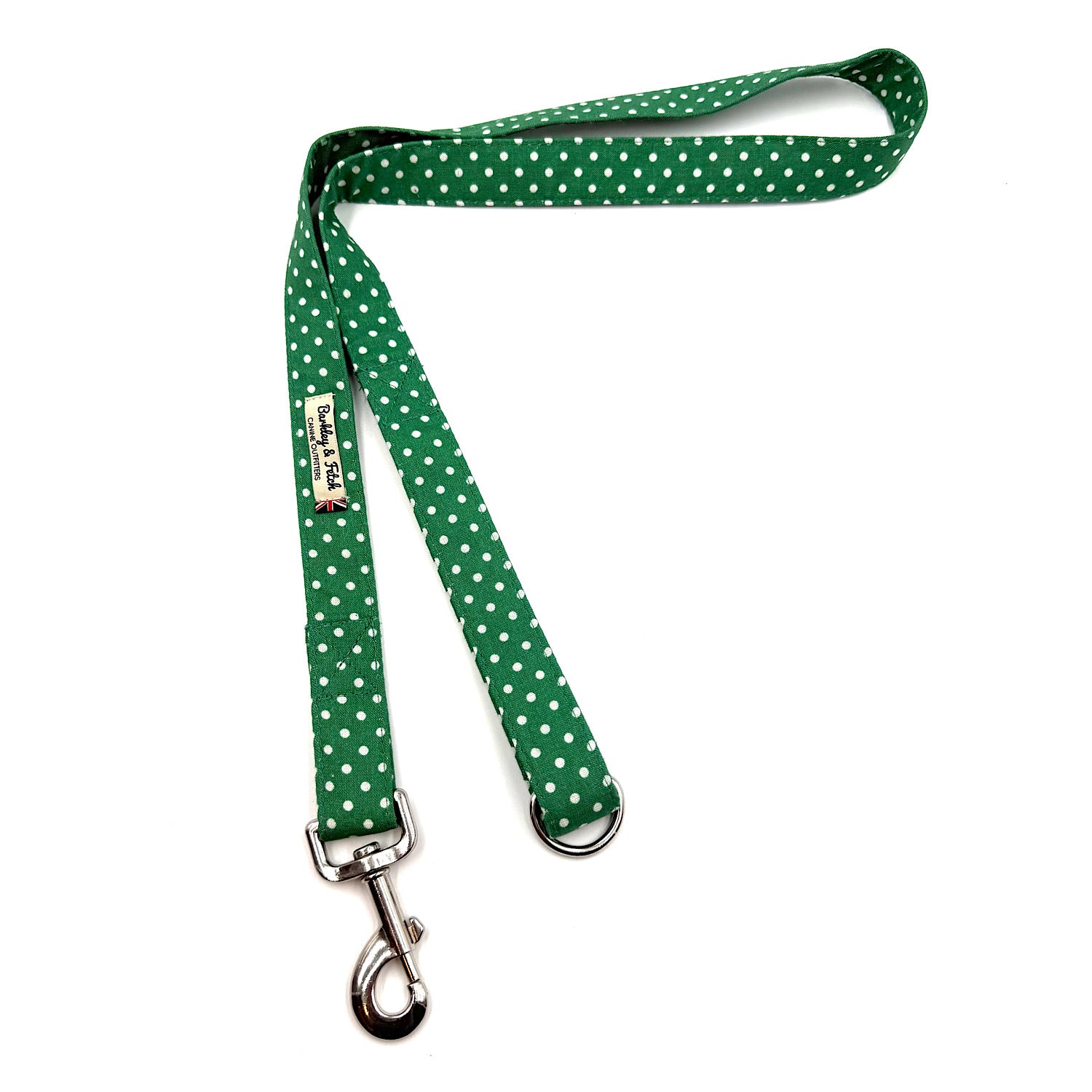 Green polka dot dog leash with a metal clip on a white background
