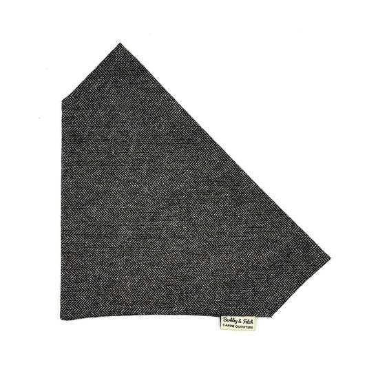 Dark gray herringbone patterned fabric on a white background