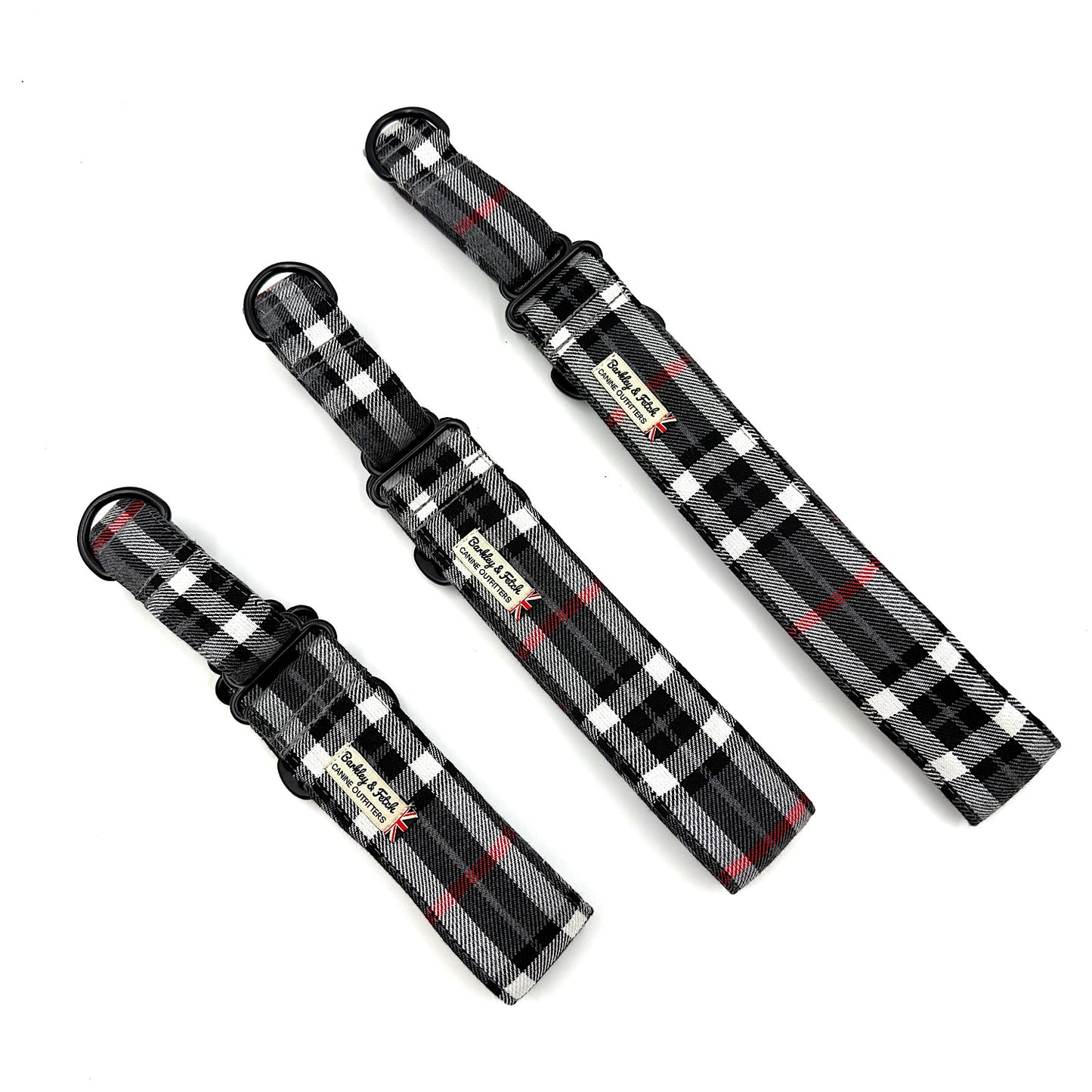 Three black and white plaid dog collars with red accents on a white background