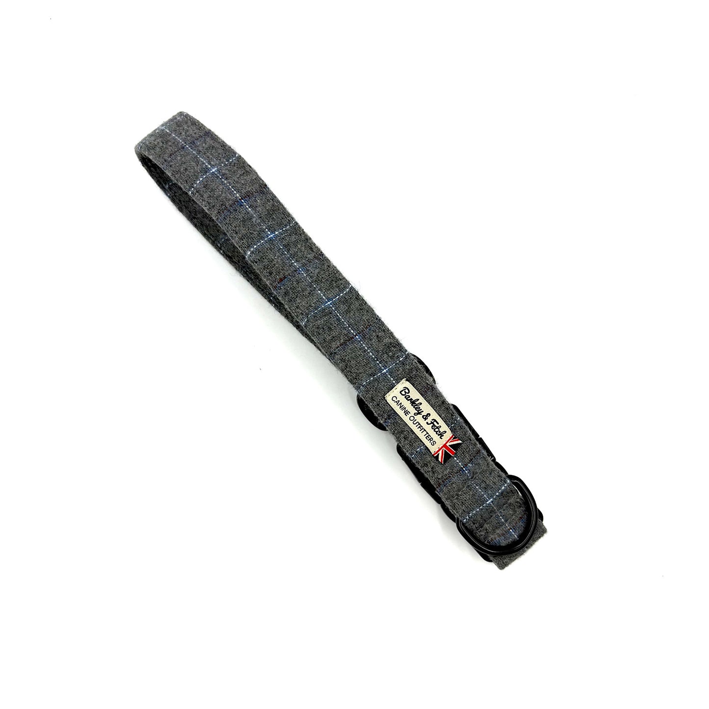 Gray plaid dog collar with a visible brand label on a white background