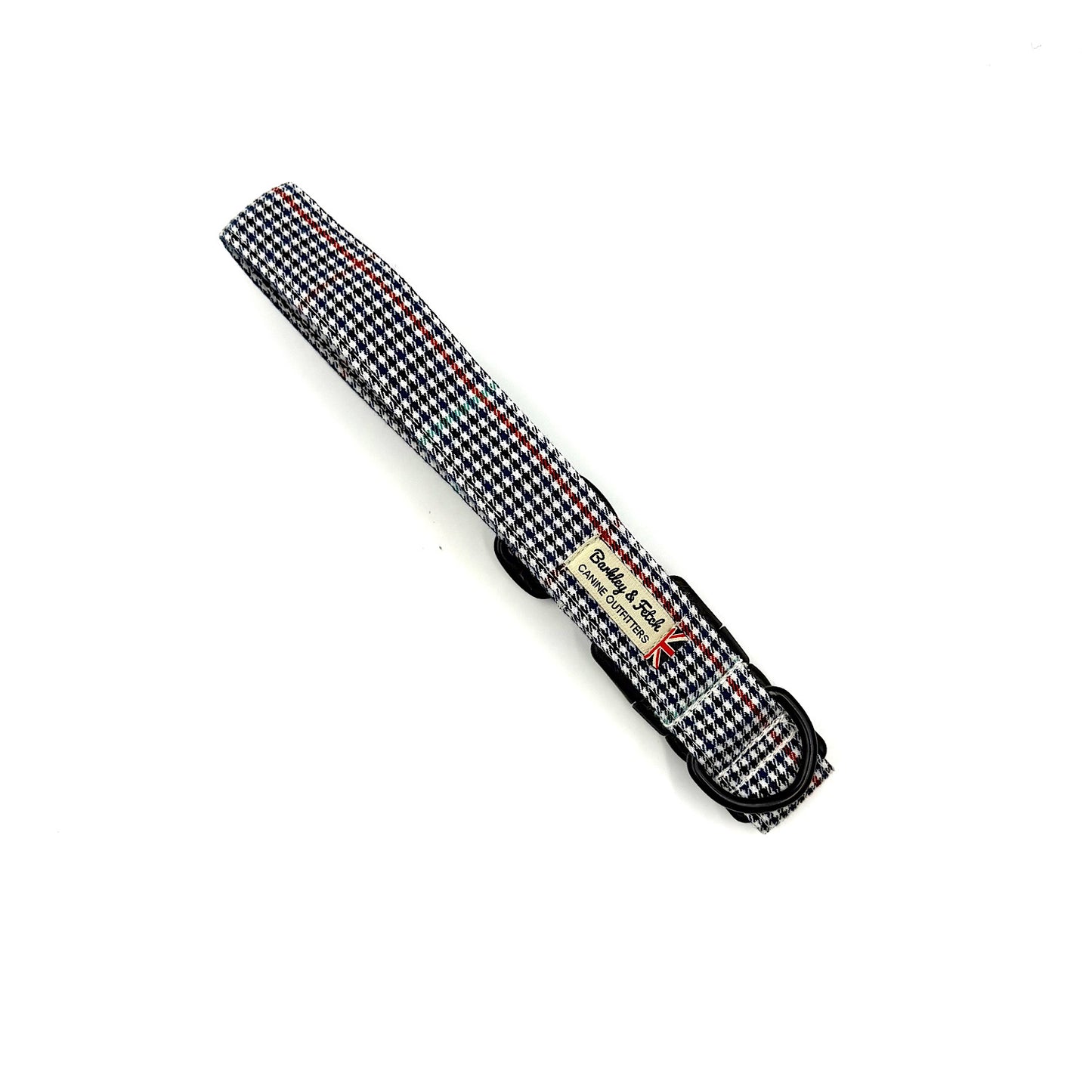 Black and white checkered dog leash with a brand label on a white background