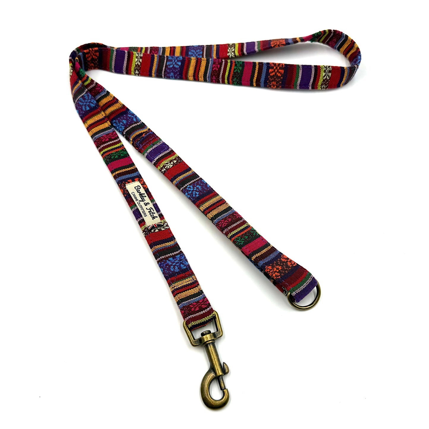 Colorful patterned dog leash with a gold clasp on a white background
