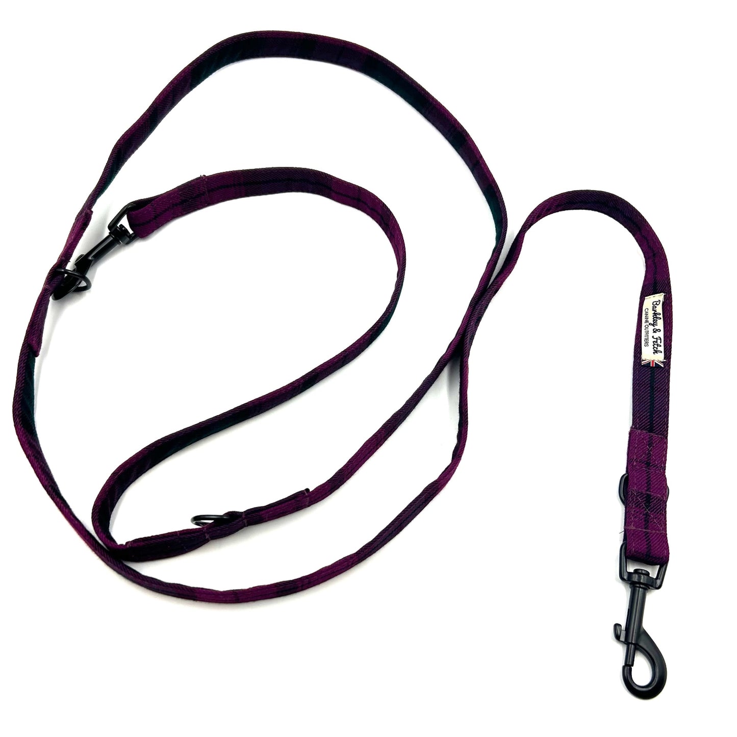 Purple dog leash with black clips on a white background