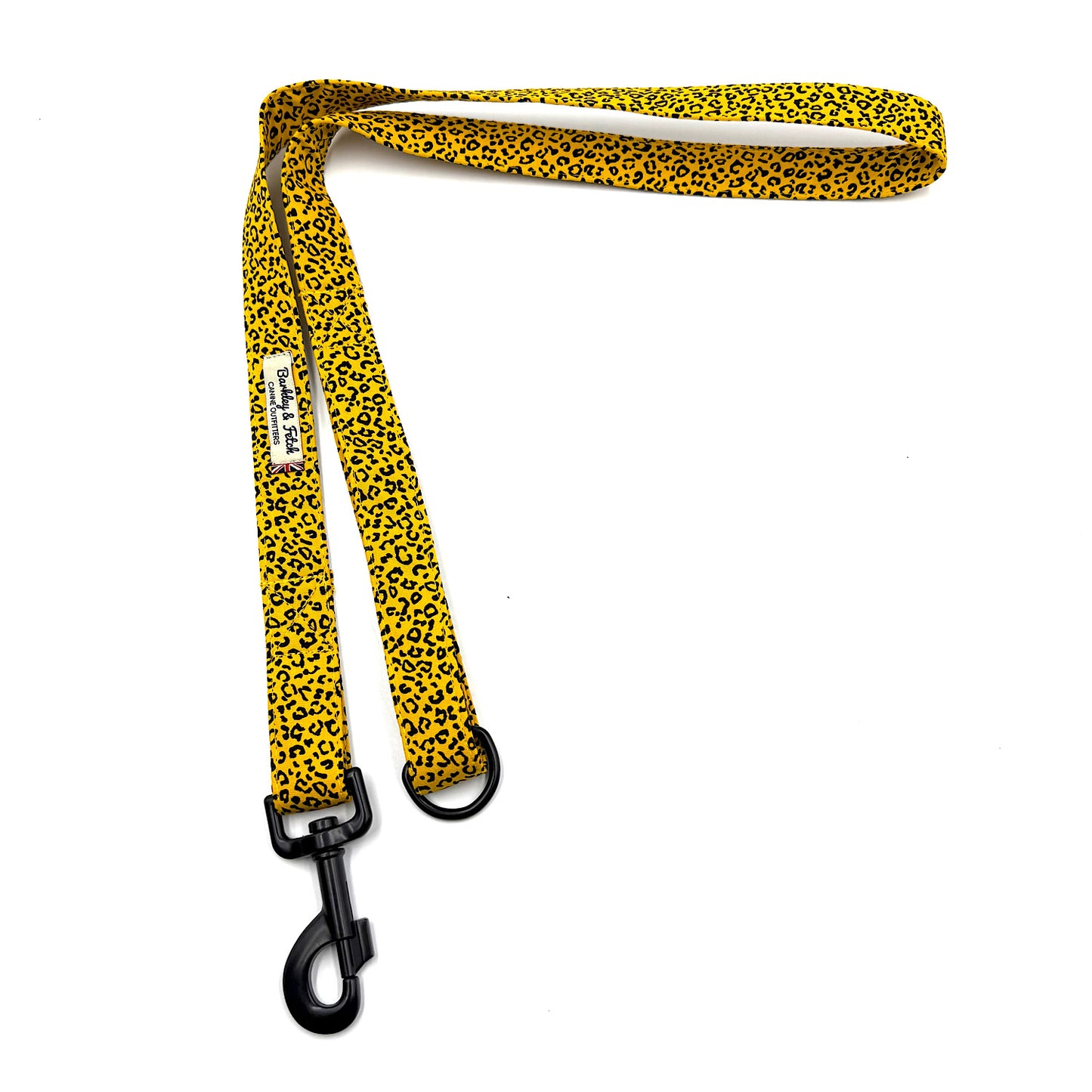 Yellow leopard print dog leash with black clip on a white background