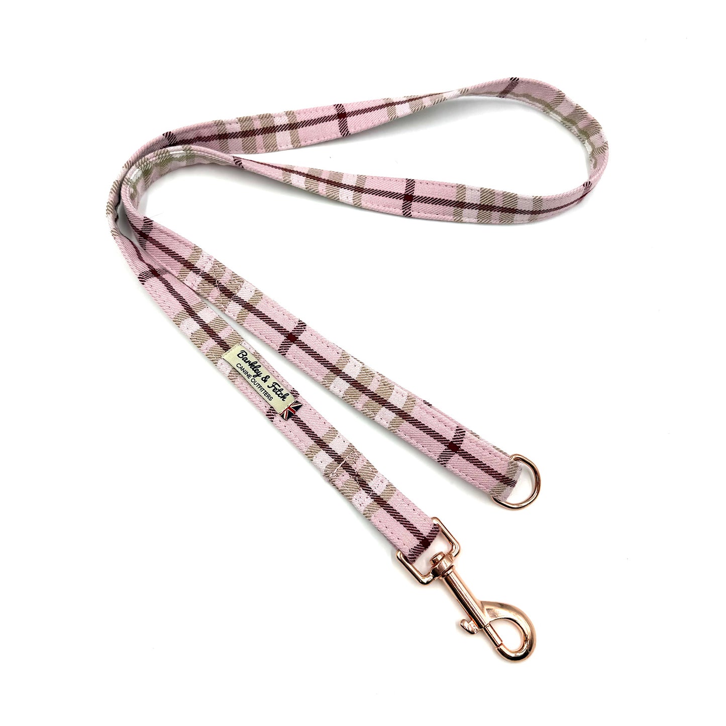 Pink plaid dog leash with gold clip on a white background