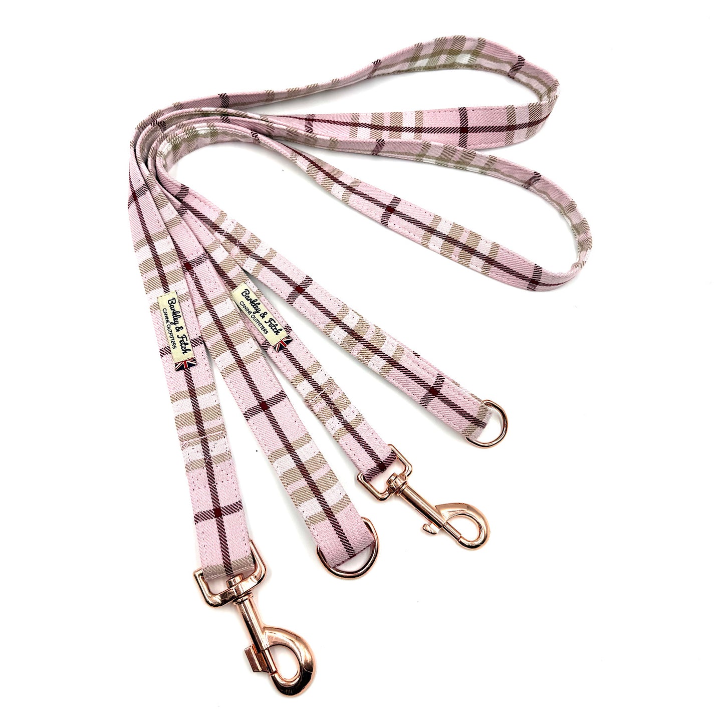 Plaid dog leashes with rose gold clips on a white background