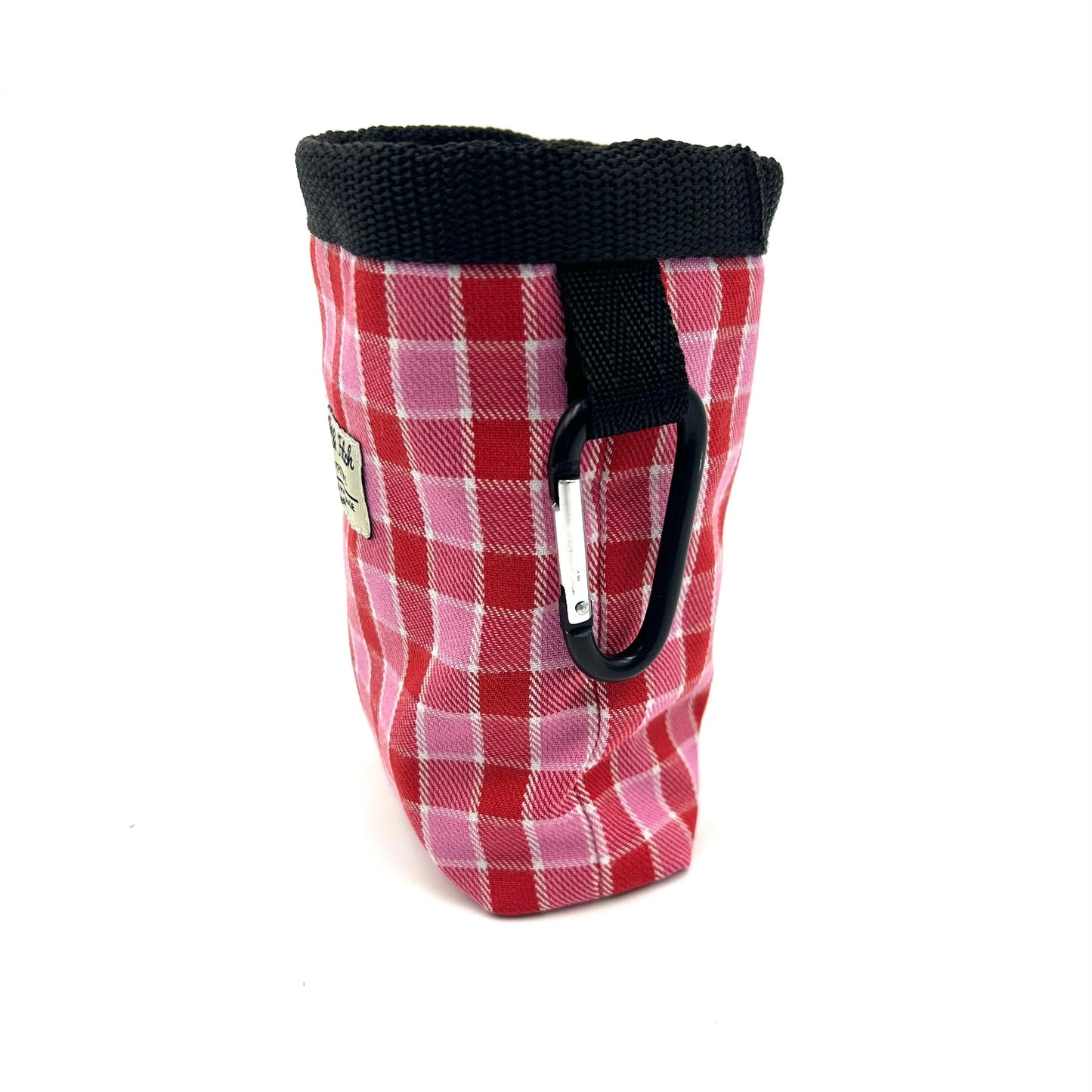 Red, pink and black plaid treat bag with carabiner on white background