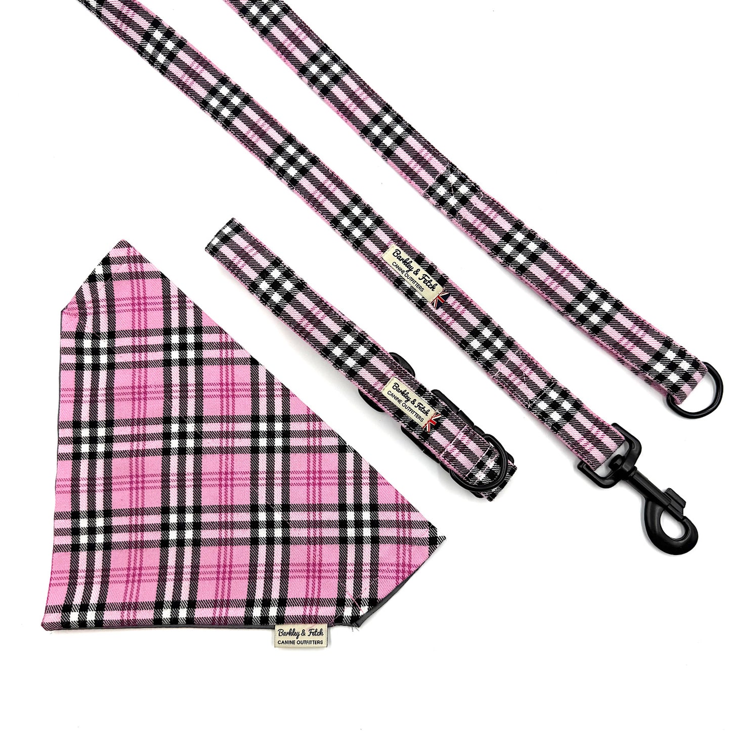 Pink and black plaid dog bandana, collar, and leash set on a white background