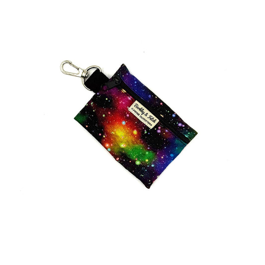 Colorful galaxy-themed keychain pouch with a visible brand label on a white background