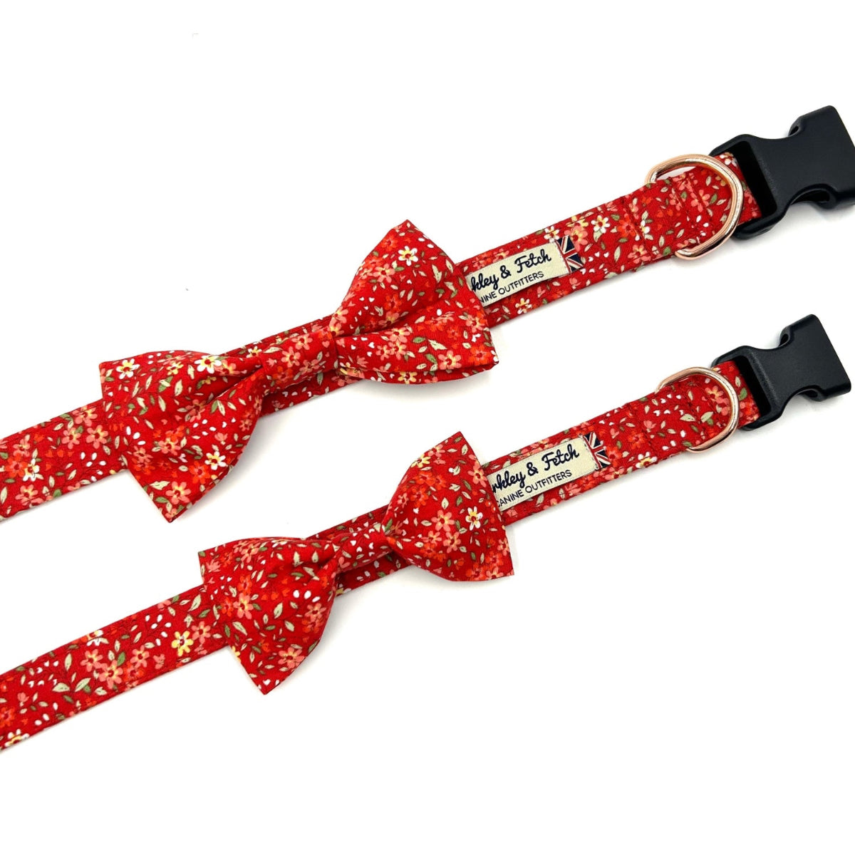 Two red floral dog collars with bow ties on a white background