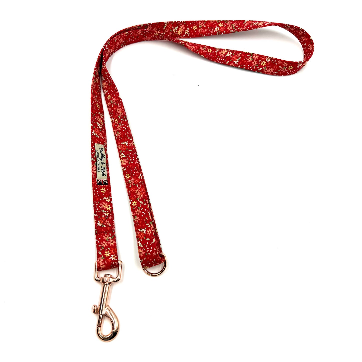 Red floral patterned dog leash with a gold clasp on a white background