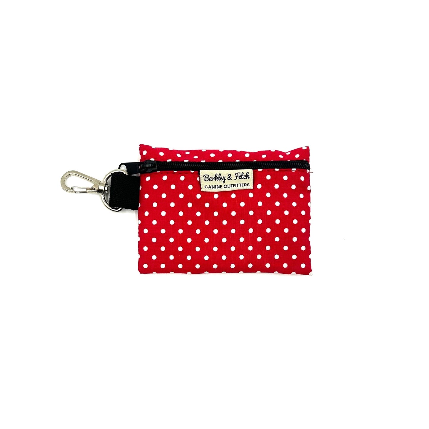 A red and white polka dot poo bag holder with a black clip and a brand label reading 'Barkley & Fetch
