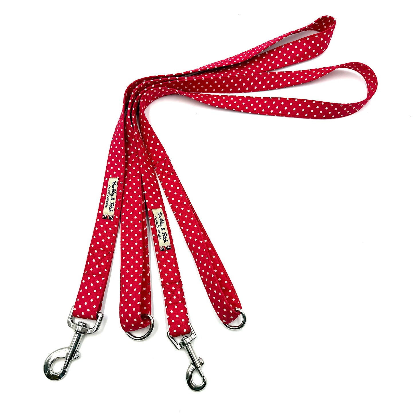 Red polka dot dog leash with metal clips on a white background