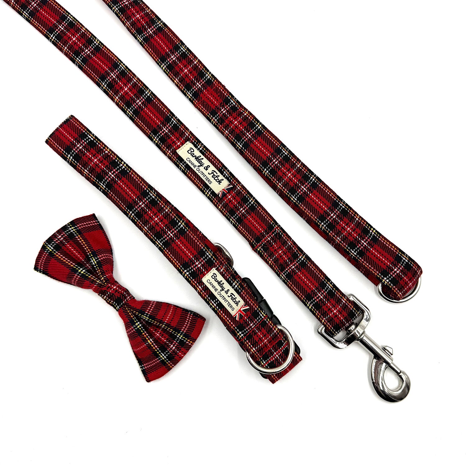 Red plaid dog collar, leash, and bow tie set on a white background