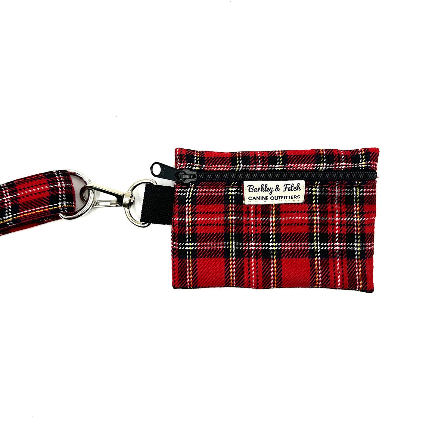Red plaid dog waste bag holder with a strap on a white background