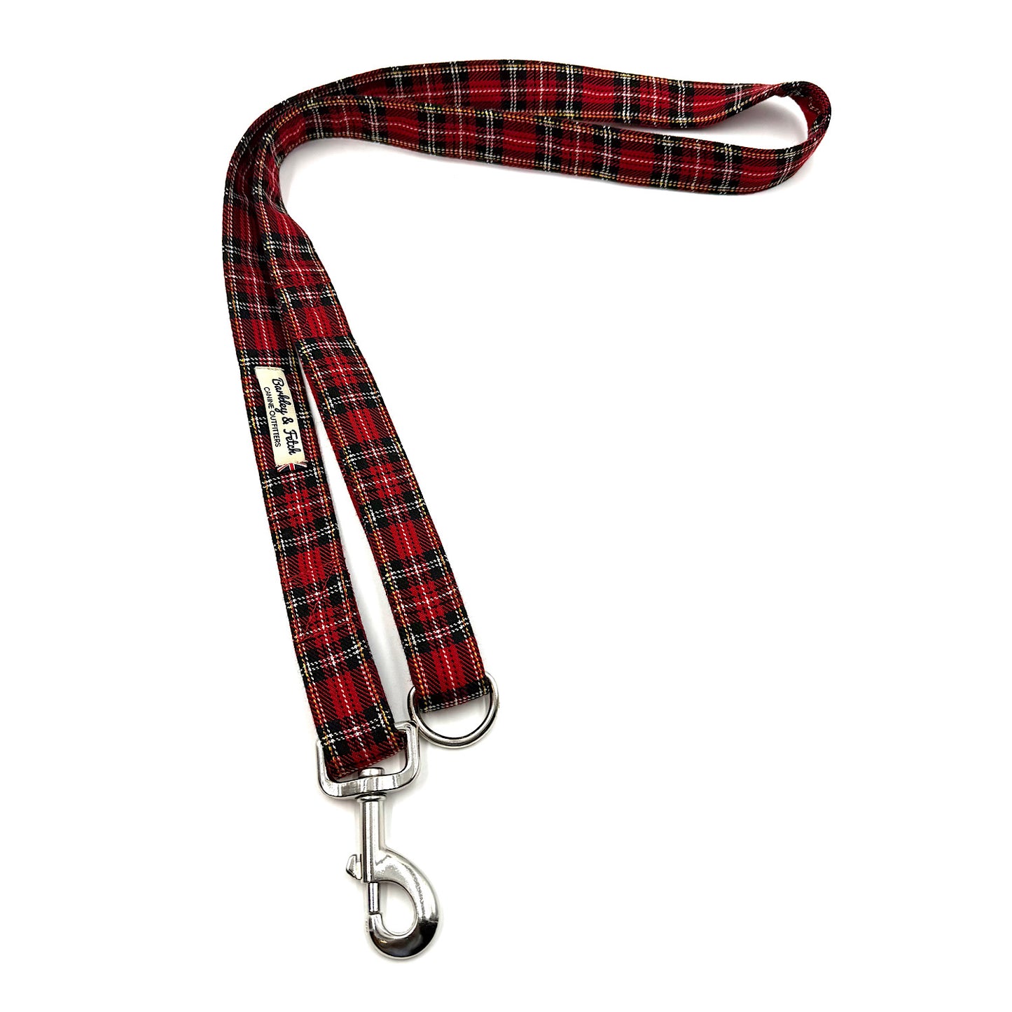 Red and black plaid dog leash with a metal clip on a white background