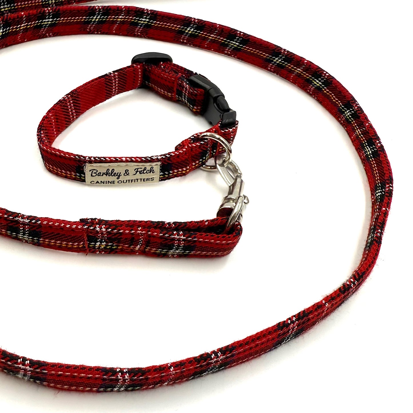 Red plaid dog leash and collar set with a visible brand label on a white background