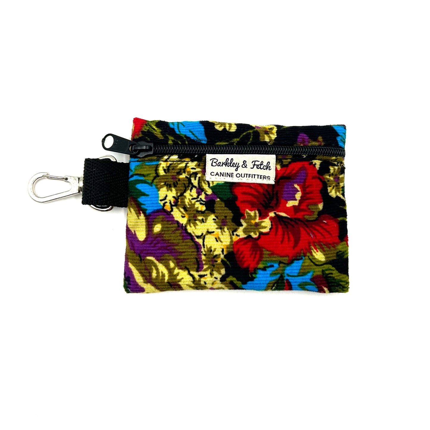 A multicolored floral corduroy poo bag holder with a label showing the brand name 'Barkley & Fetch'.