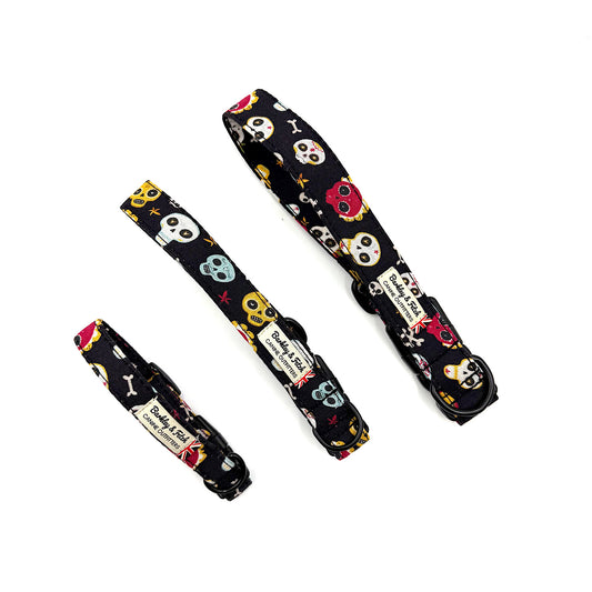 Three dog collars with skull and crossbones pattern on a white background